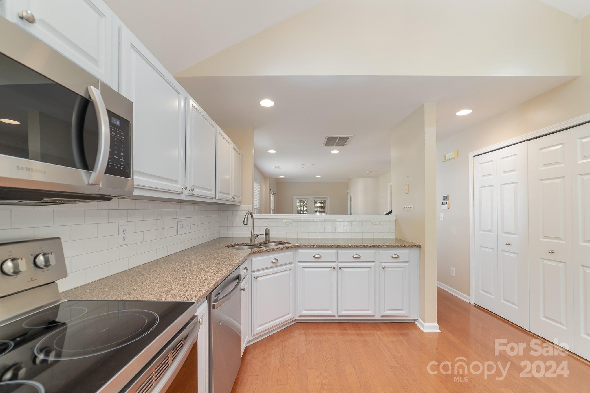 11546 Rabbit Ridge Road Charlotte, NC 28270 - Photo 7 of 17 a kitchen with a sink cabinets and stainless steel appliances