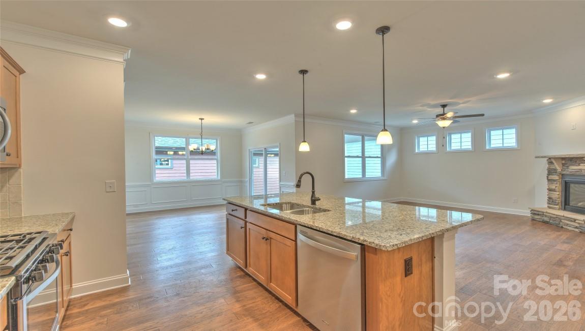 649 River Btm Road Fletcher, NC 28732 - Photo 12 of 40 a kitchen with granite countertop kitchen island wooden floors cabinets and stainless steel appliances