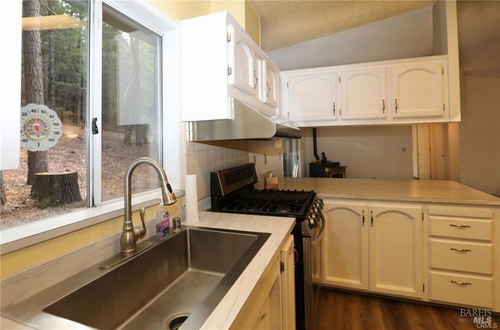 9356 Rockys Road Kelseyville, CA 95451 - Photo 11 of 24 a kitchen with granite countertop a sink stainless steel appliances and cabinets