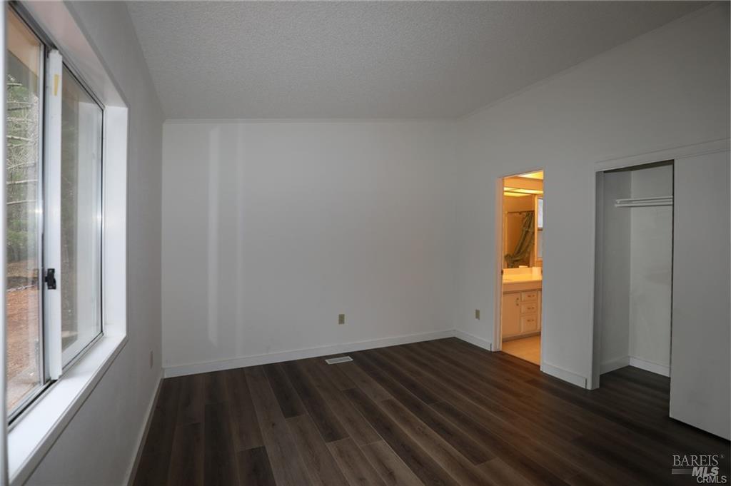 9356 Rockys Road Kelseyville, CA 95451 - Photo 14 of 24 a view of empty room with wooden floor and fan