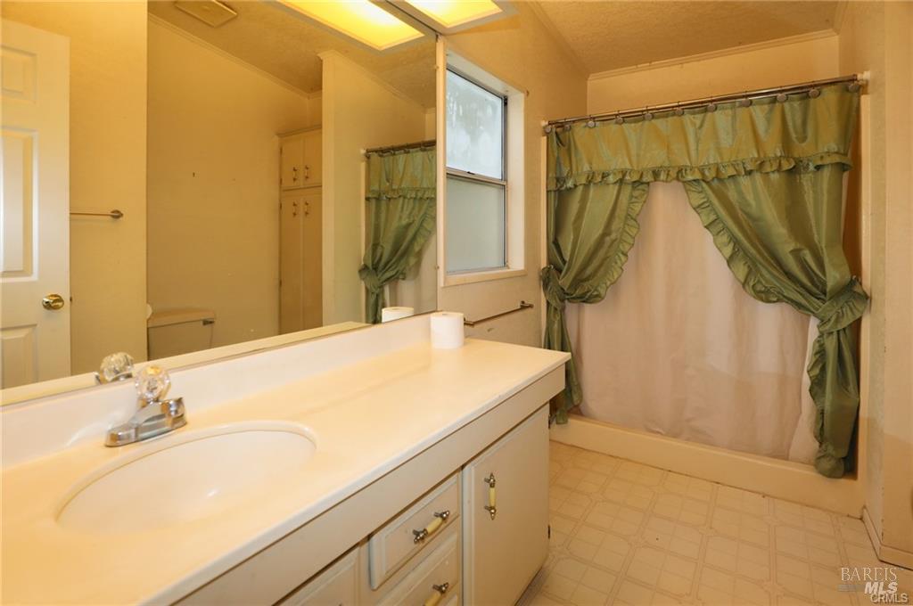9356 Rockys Road Kelseyville, CA 95451 - Photo 16 of 24 a bathroom with a granite countertop sink and a mirror