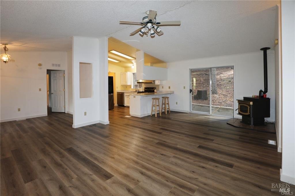 9356 Rockys Road Kelseyville, CA 95451 - Photo 5 of 24 a view of a kitchen counter space with wooden floor and a ceiling fan