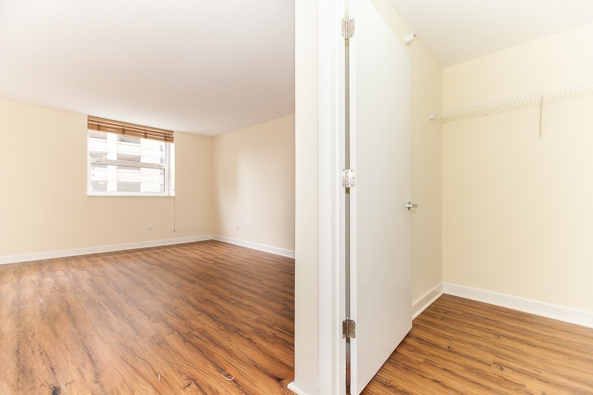 545 North Dearborn Street, Unit 902 Chicago, IL 60654 - Photo 12 of 16 a view of an empty room with wooden floor and a window