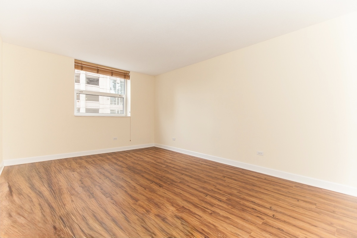 545 North Dearborn Street, Unit 902 Chicago, IL 60654 - Photo 10 of 16 an empty room with wooden floor and windows