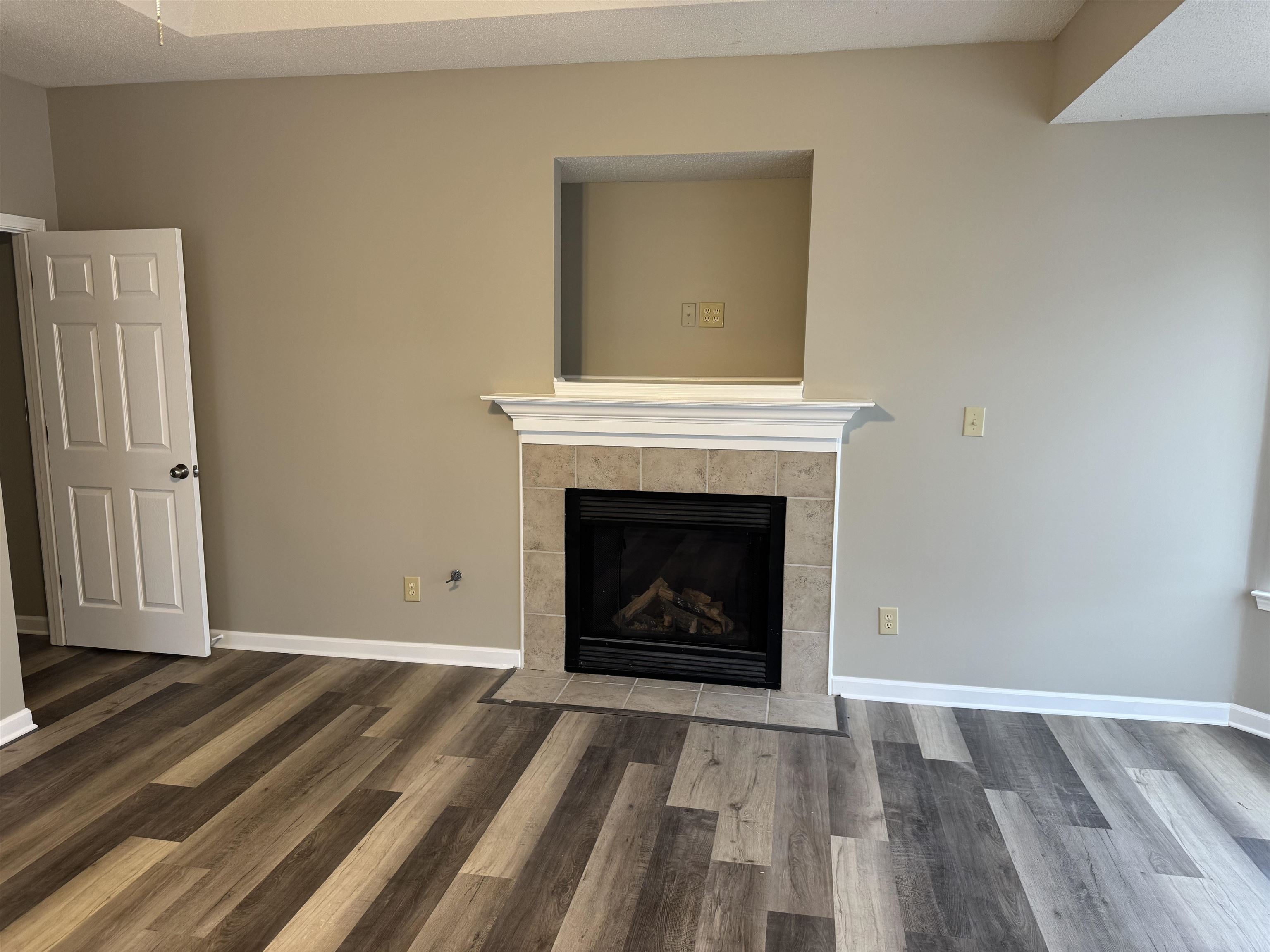 5393 Hightor Lane Memphis, TN 38125 - Photo 22 of 28 a view of an empty room with wooden floor fireplace and a window