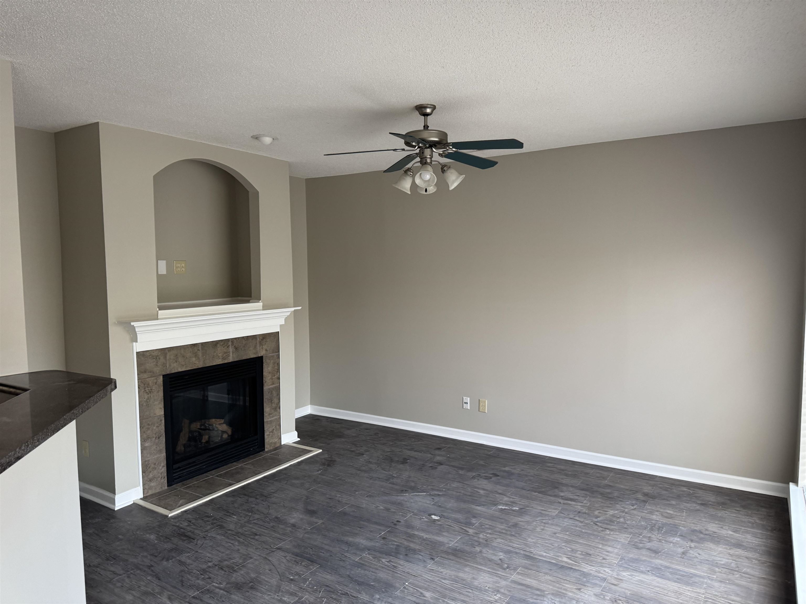 5393 Hightor Lane Memphis, TN 38125 - Photo 24 of 28 an empty room with chandelier fan and fireplace