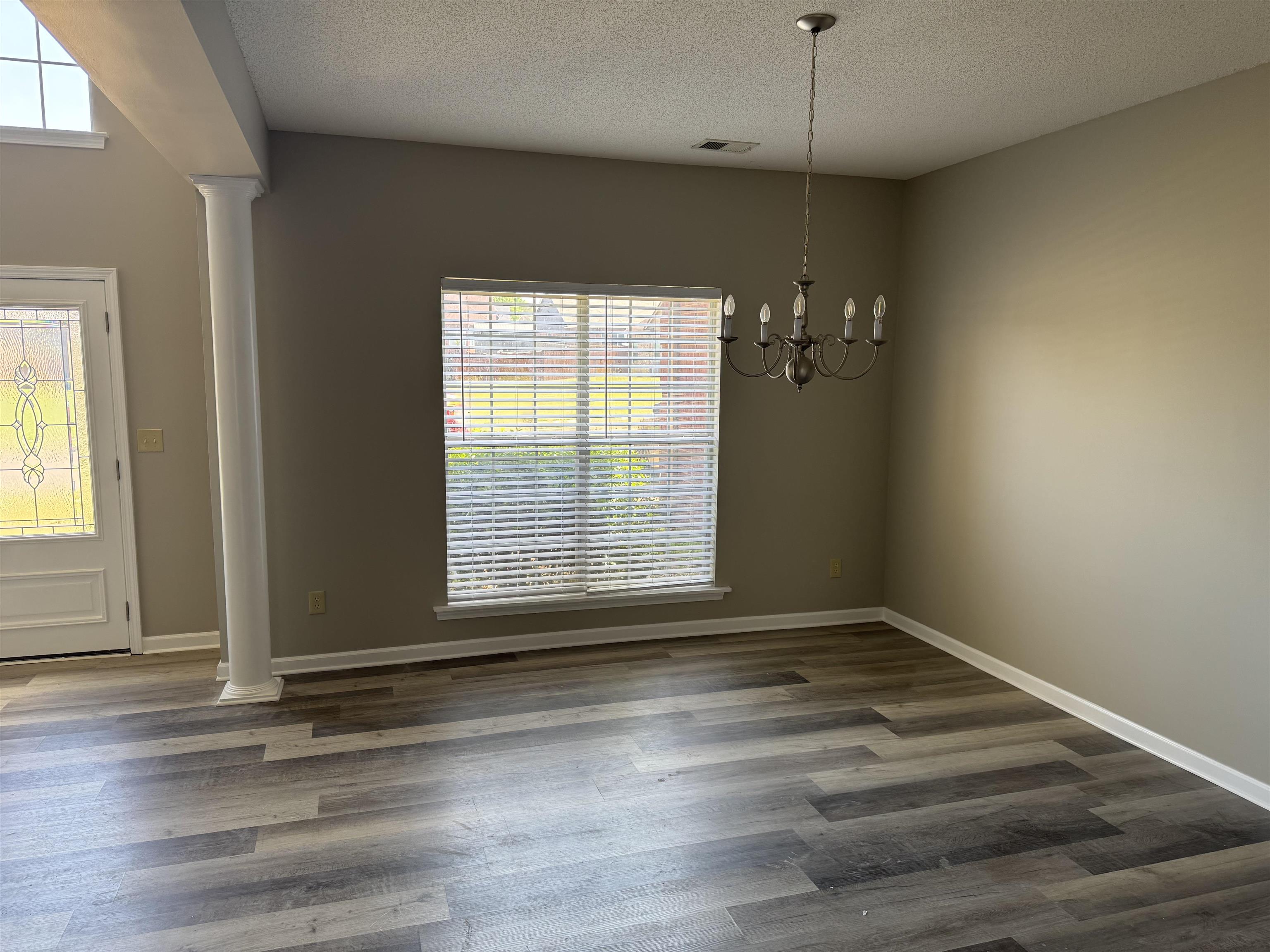 5393 Hightor Lane Memphis, TN 38125 - Photo 28 of 28 a view of an empty room with wooden floor and a window