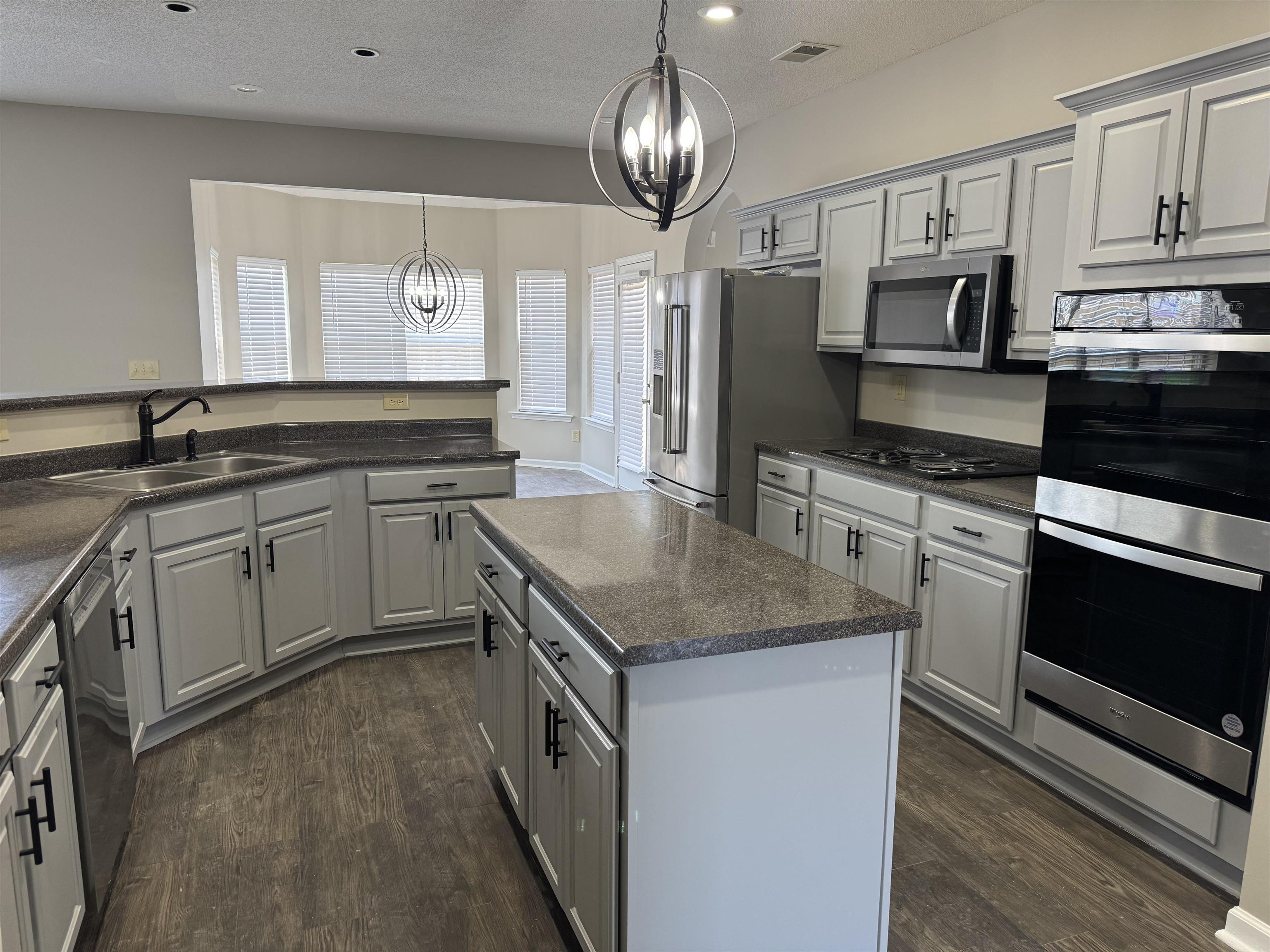 5393 Hightor Lane Memphis, TN 38125 - Photo 5 of 28 a kitchen with stainless steel appliances granite countertop a sink stove and refrigerator
