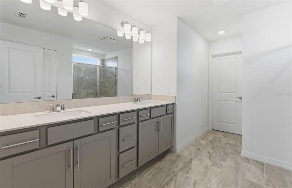 1448 Hamilton Way Lake Alfred, FL 33850 - Photo 11 of 32 a bathroom with double sink and a mirror