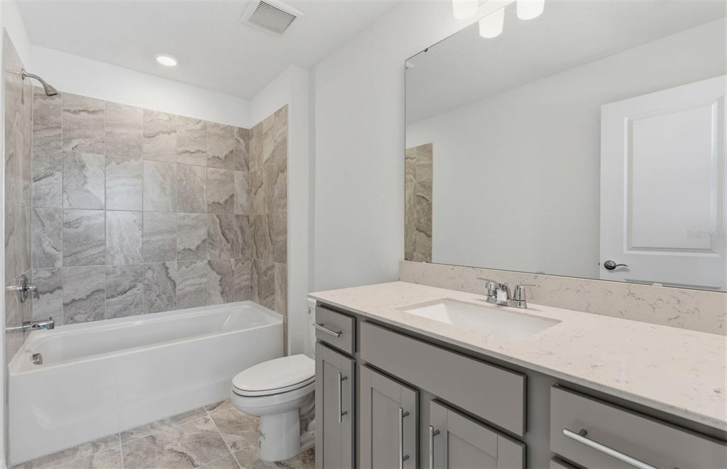 1448 Hamilton Way Lake Alfred, FL 33850 - Photo 15 of 32 a bathroom with a sink toilet and bathtub