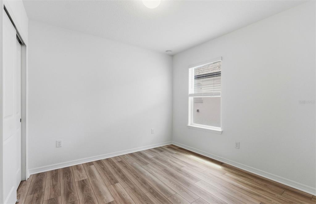 1448 Hamilton Way Lake Alfred, FL 33850 - Photo 8 of 32 a view of empty room with wooden floor and fan