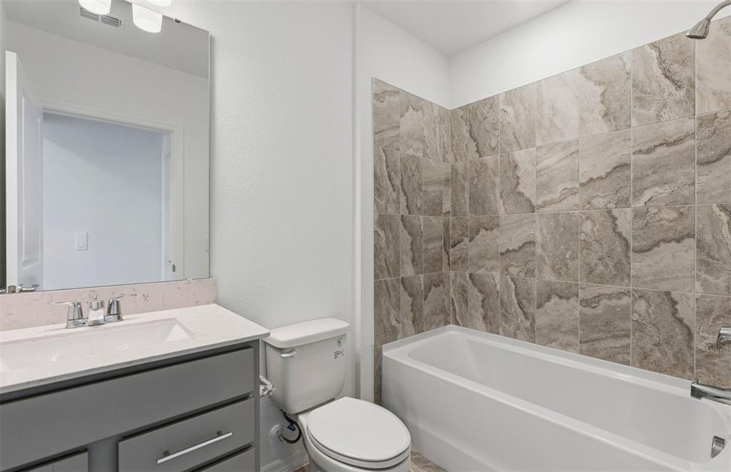 1448 Hamilton Way Lake Alfred, FL 33850 - Photo 9 of 32 a bathroom with a granite countertop sink toilet and bathtub