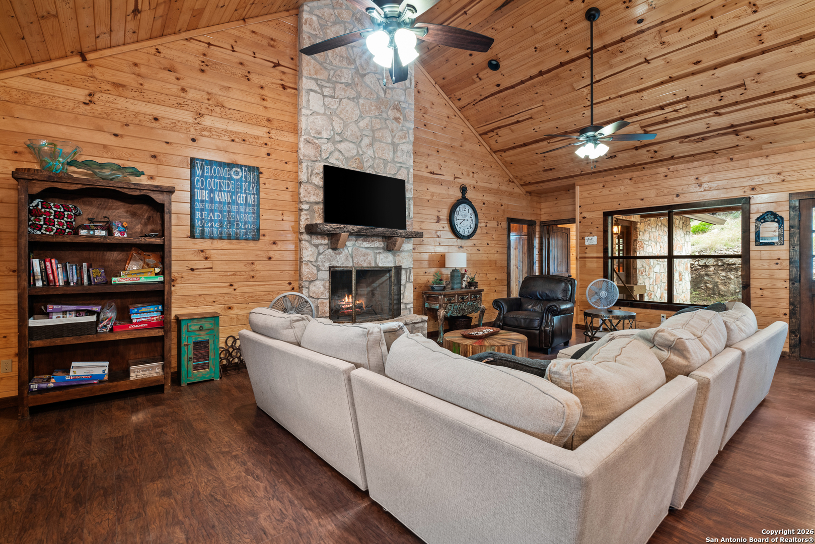 1539 River Road Concan, TX 78838 - Photo 14 of 45 a living room with furniture a flat screen tv and a fireplace