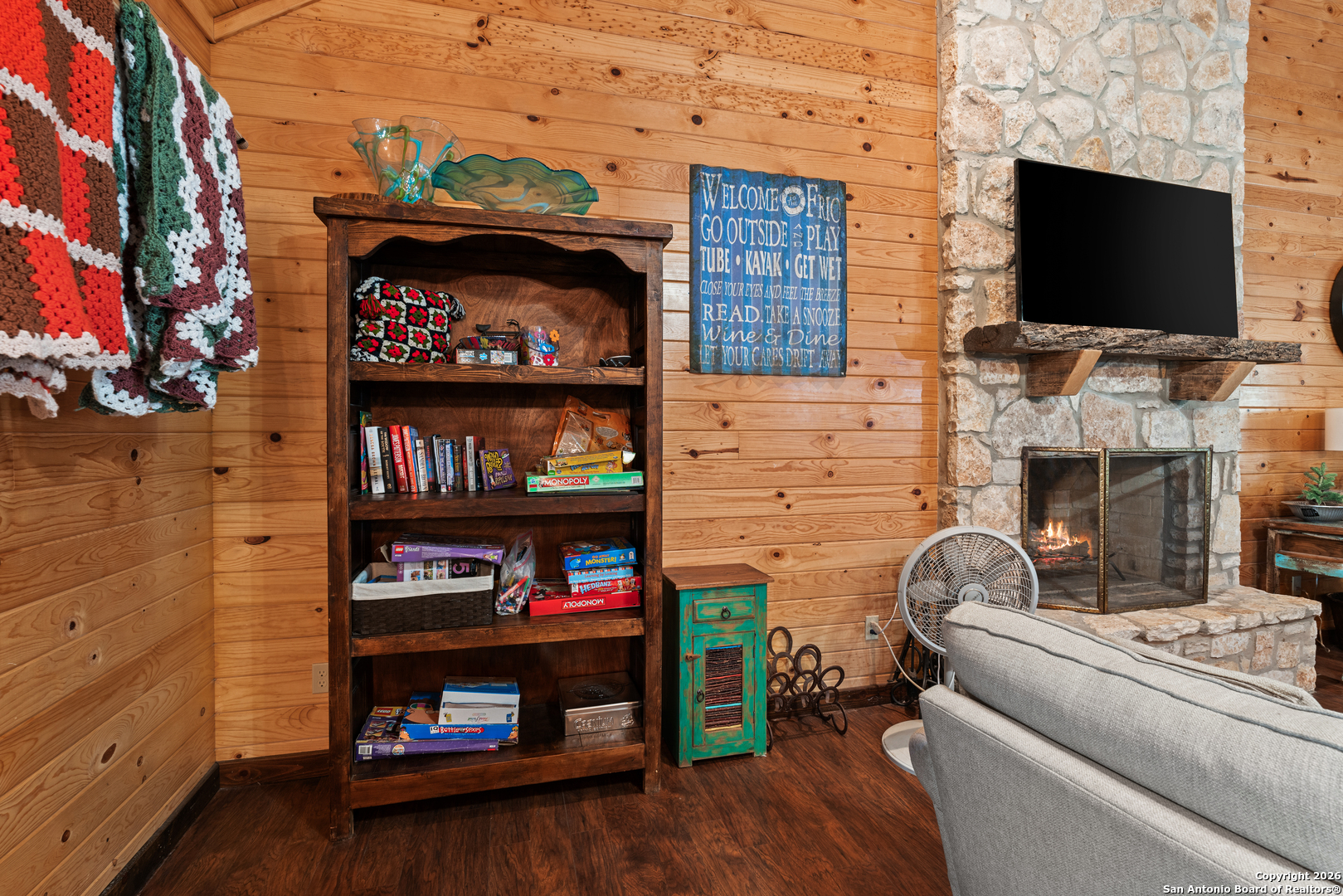1539 River Road Concan, TX 78838 - Photo 15 of 45 a living room with fireplace and a flat screen tv