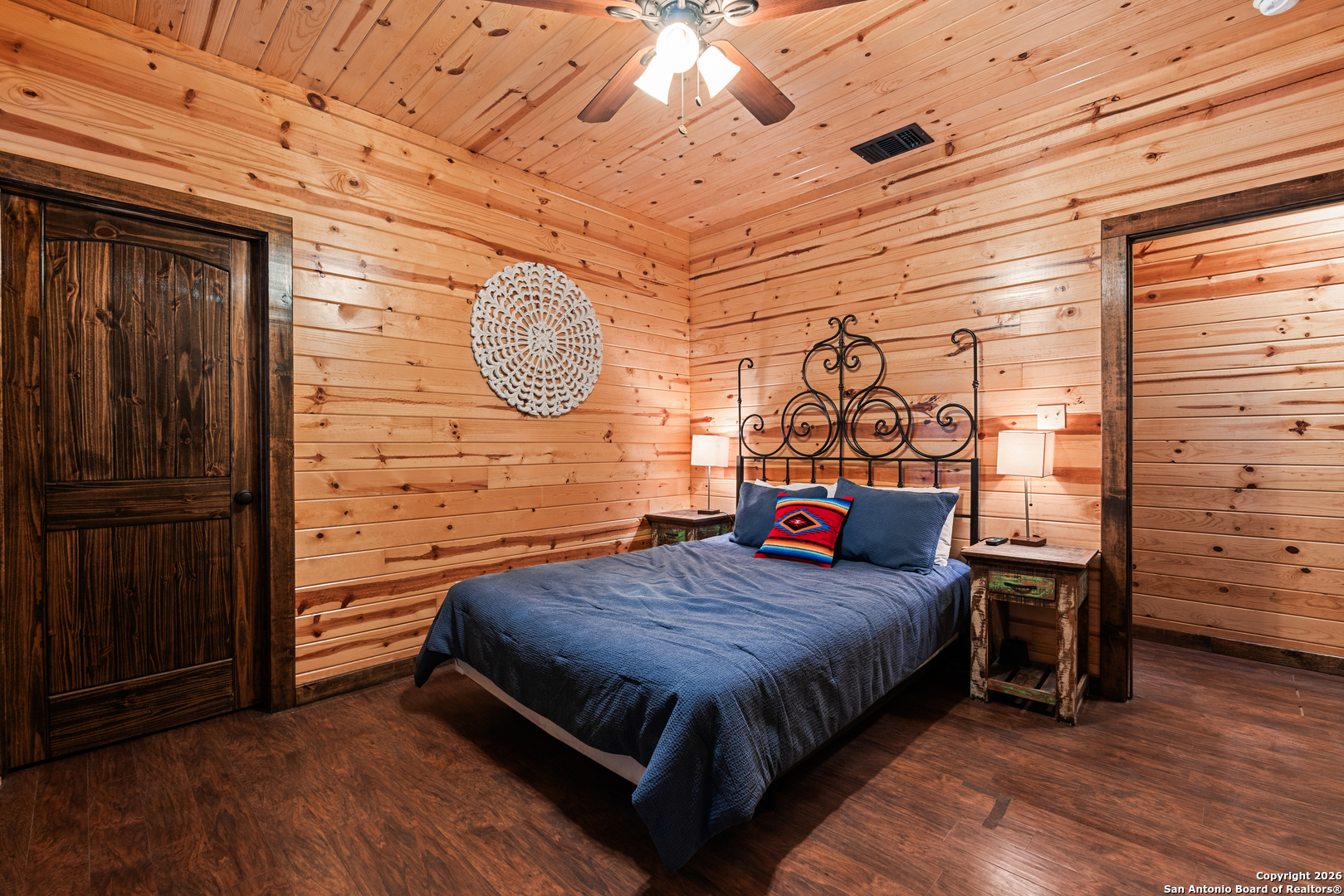 1539 River Road Concan, TX 78838 - Photo 23 of 45 a bedroom with a bed and wooden floor