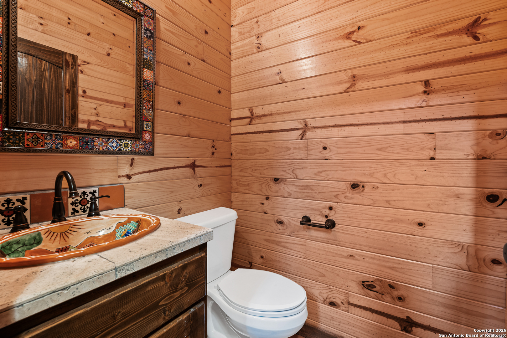 1539 River Road Concan, TX 78838 - Photo 26 of 45 a bathroom with a granite countertop toilet and a sink