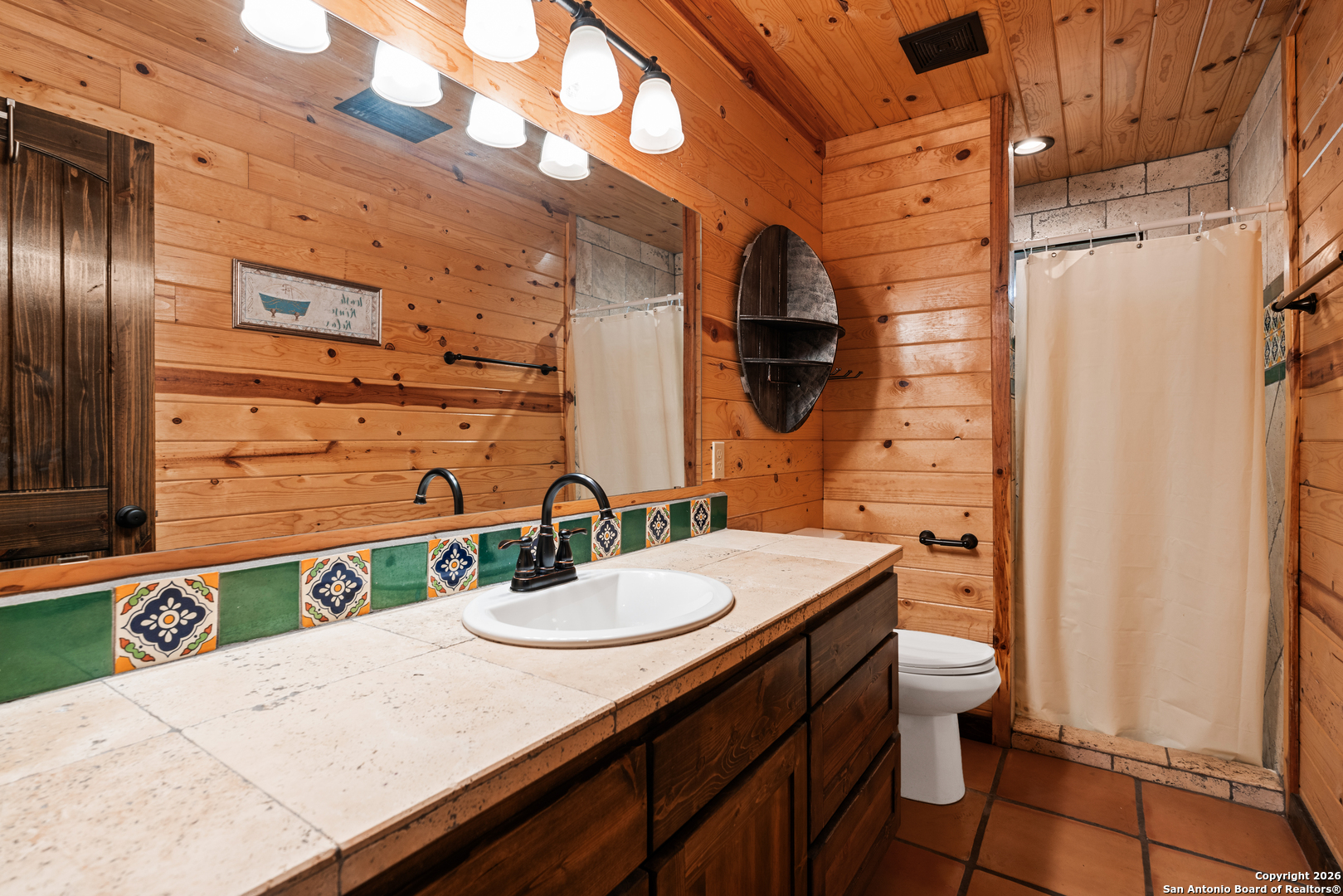 1539 River Road Concan, TX 78838 - Photo 31 of 45 a bathroom with a sink a mirror and a toilet