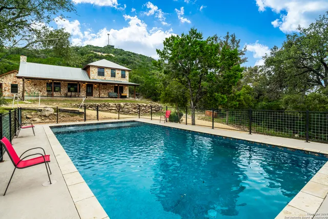 a view of a house with backyard porch and sitting area