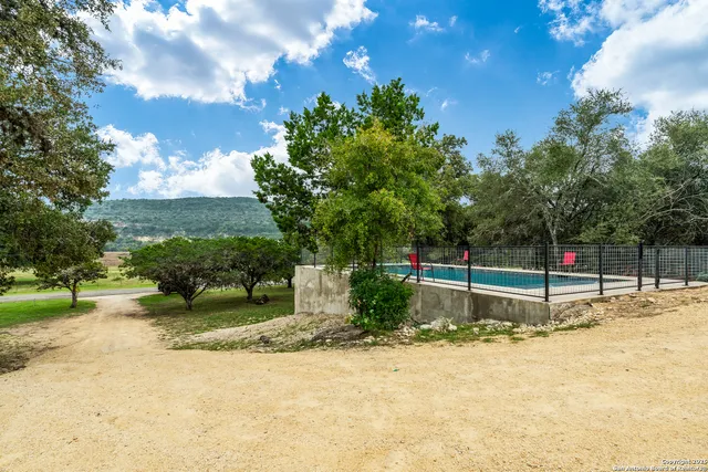 swimming pool view with a lake view