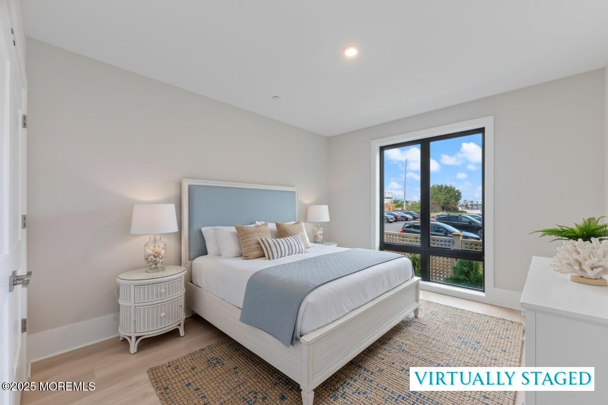 215 2nd Avenue, Unit 103 Asbury Park, NJ 07712 - Photo 12 of 33 a bedroom with a bed and large window