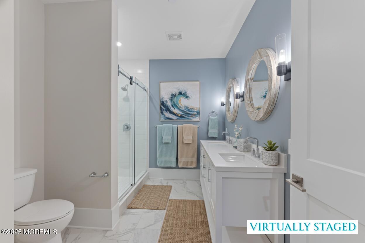 215 2nd Avenue, Unit 103 Asbury Park, NJ 07712 - Photo 18 of 33 a bathroom with a sink toilet and mirror