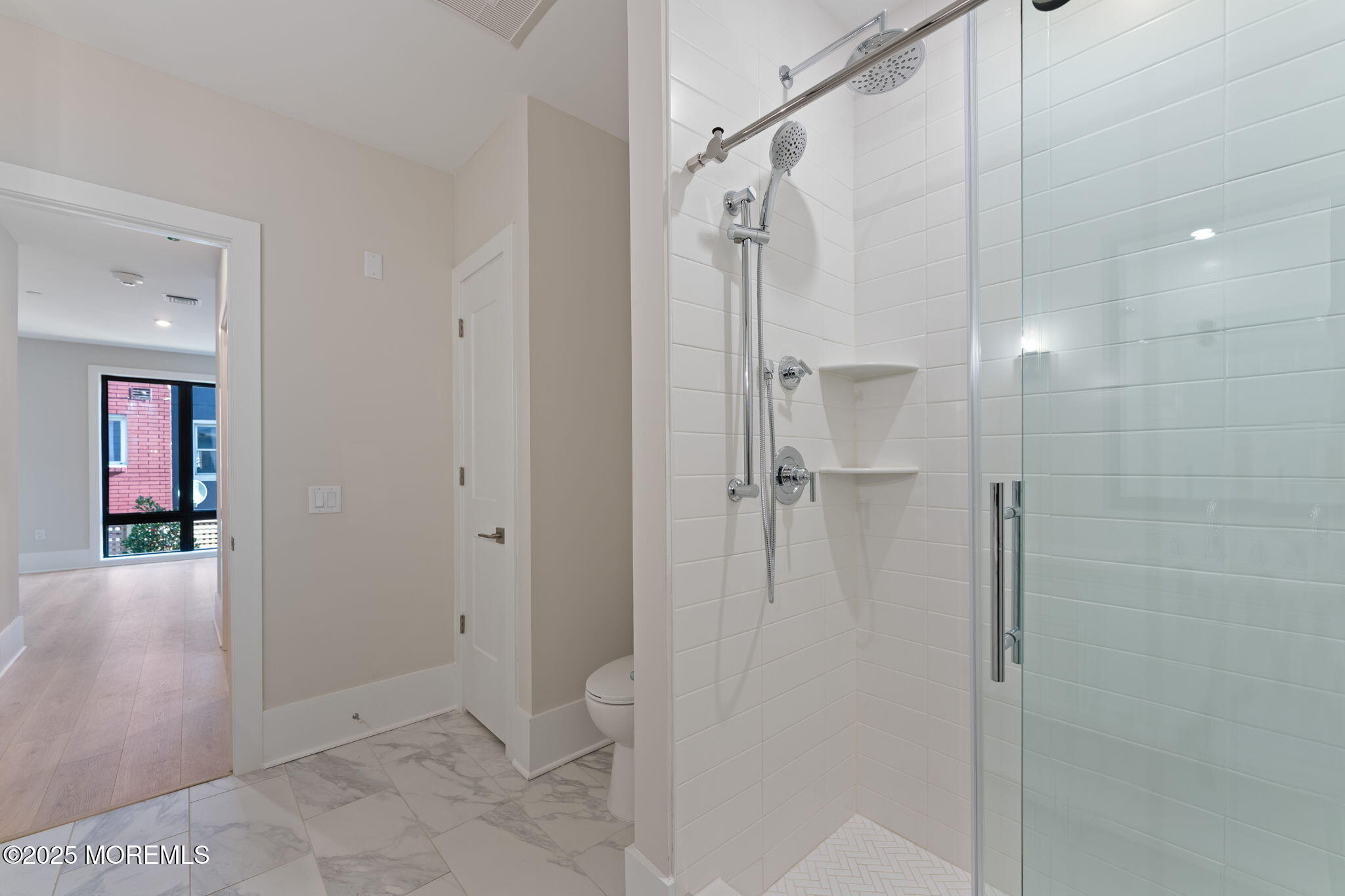 215 2nd Avenue, Unit 103 Asbury Park, NJ 07712 - Photo 20 of 33 a bathroom with a shower and a glass door