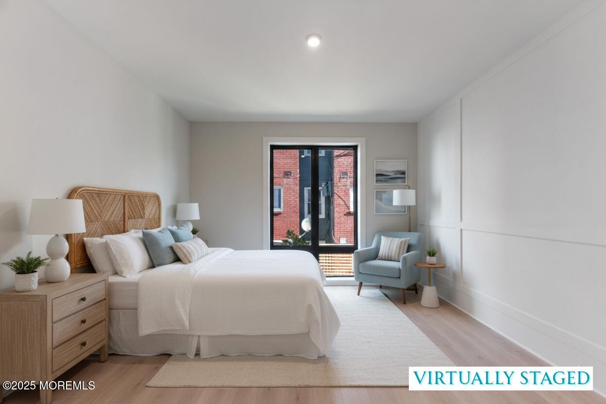 215 2nd Avenue, Unit 103 Asbury Park, NJ 07712 - Photo 22 of 33 a bedroom with a large bed and a couch