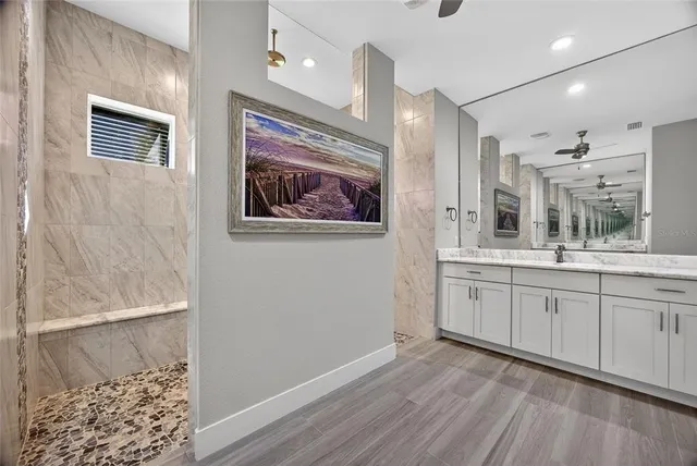 a spacious bathroom with a double vanity sink and a window