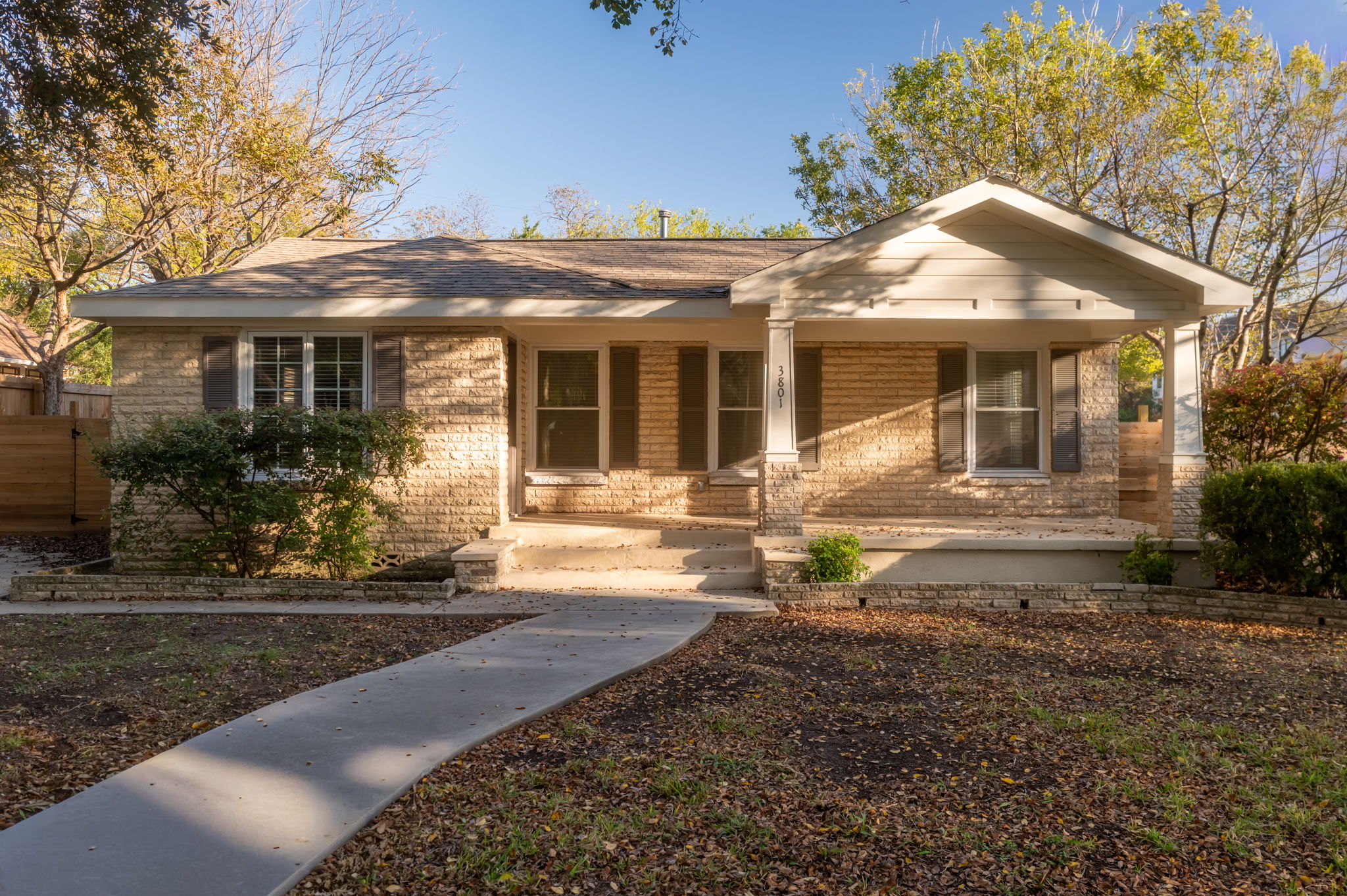 View of front of home featuring covered porch and brick siding
