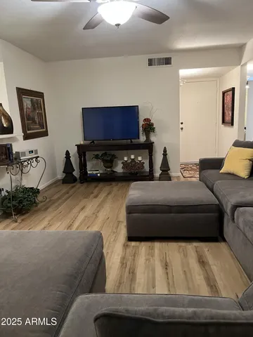 a room with gym equipment and wooden floor