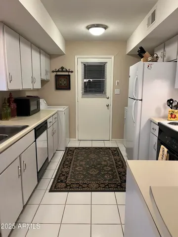 a kitchen with a sink a stove and cabinets