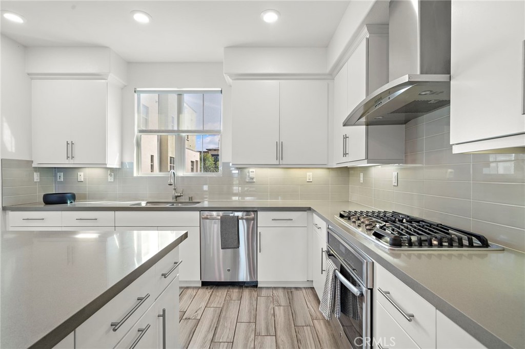 144 Paramount Irvine, CA 92618 - Photo 3 of 43 a kitchen with stainless steel appliances a sink a stove and cabinets