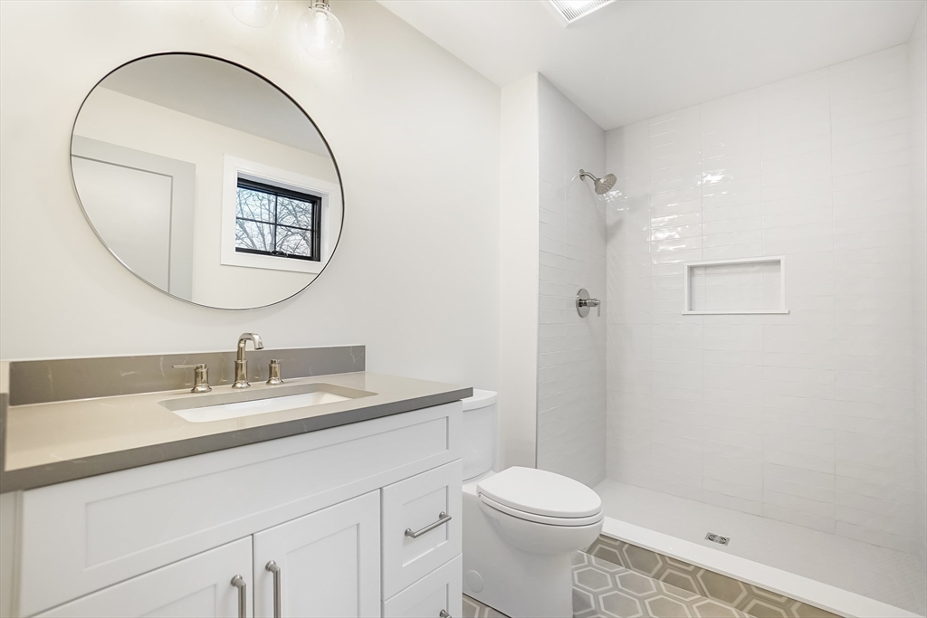 407 High Rock Street Needham, MA 02492 - Photo 24 of 36 a bathroom with a sink a toilet and a mirror