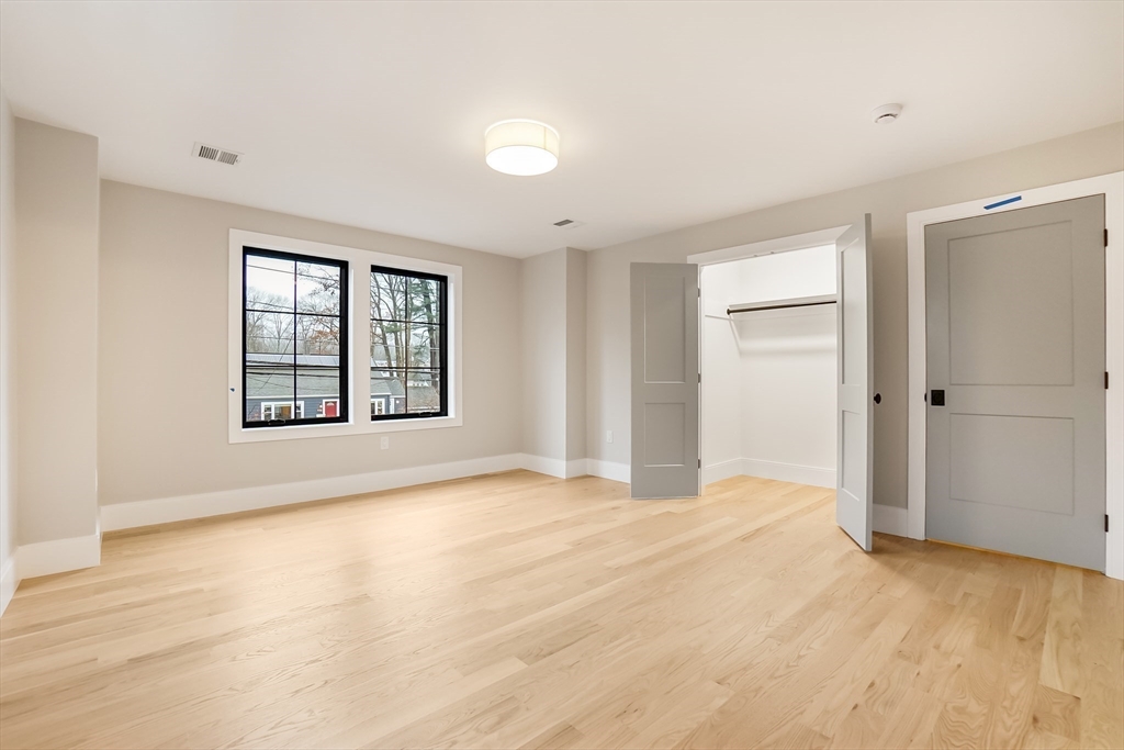 407 High Rock Street Needham, MA 02492 - Photo 27 of 36 a view of an empty room with glass door and wooden floor