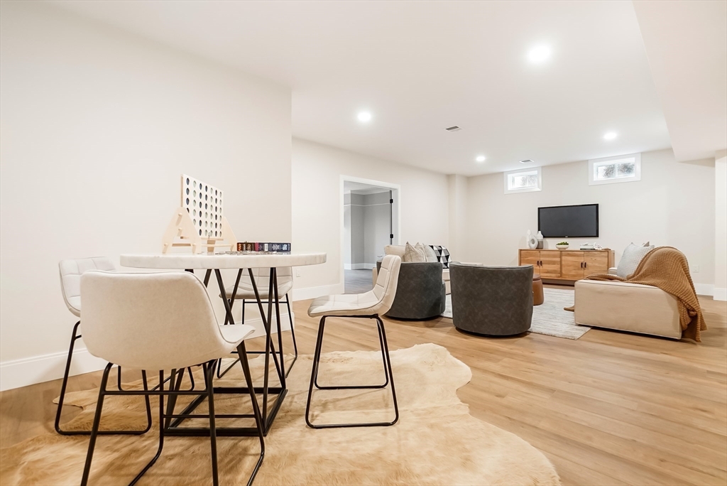 407 High Rock Street Needham, MA 02492 - Photo 30 of 36 a living room with furniture a flat screen tv and a table