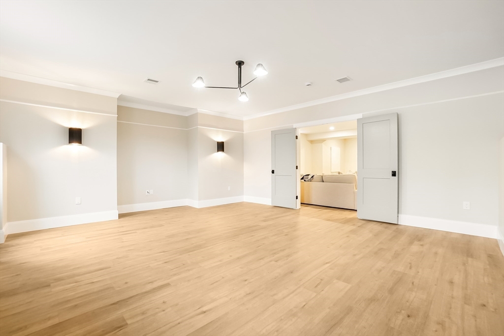 407 High Rock Street Needham, MA 02492 - Photo 31 of 36 a view of empty room with wooden floor and windows
