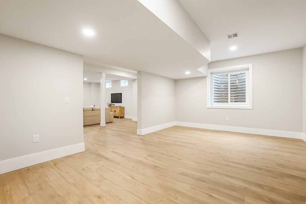 407 High Rock Street Needham, MA 02492 - Photo 35 of 36 a view of an empty room with a window and wooden floor