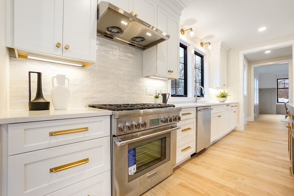 407 High Rock Street Needham, MA 02492 - Photo 9 of 36 a kitchen with stainless steel appliances a stove and cabinets