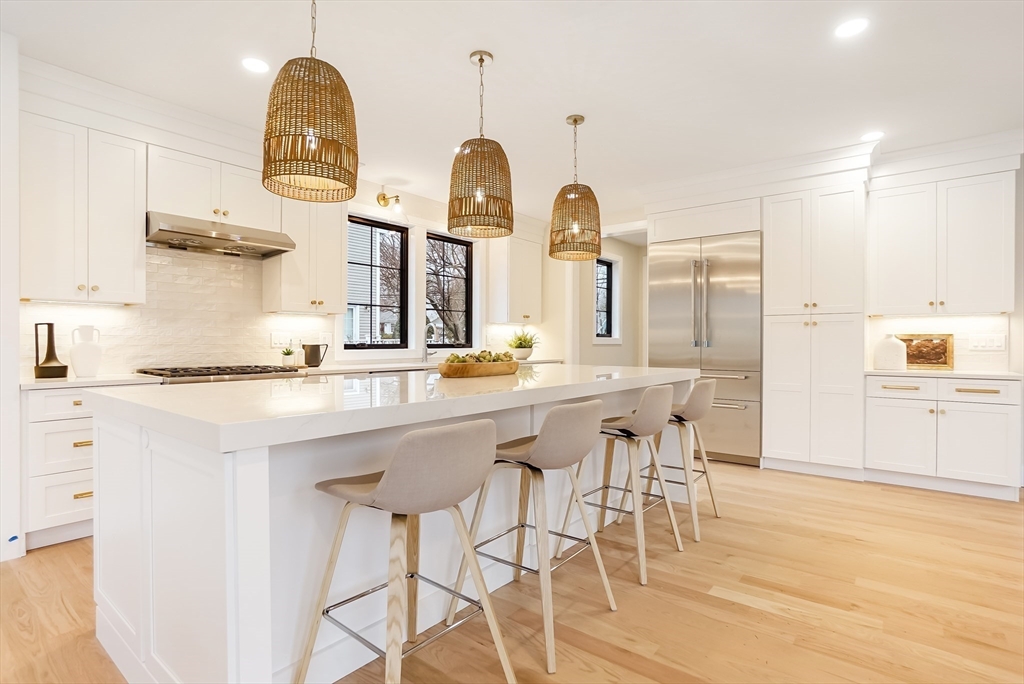 407 High Rock Street Needham, MA 02492 - Photo 10 of 36 a kitchen with stainless steel appliances granite countertop a sink a stove and cabinets