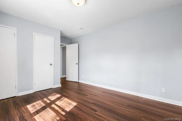 a view of an empty room and wooden floor