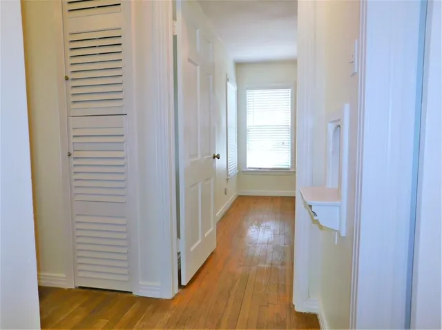 a view of a hallway with wooden floor