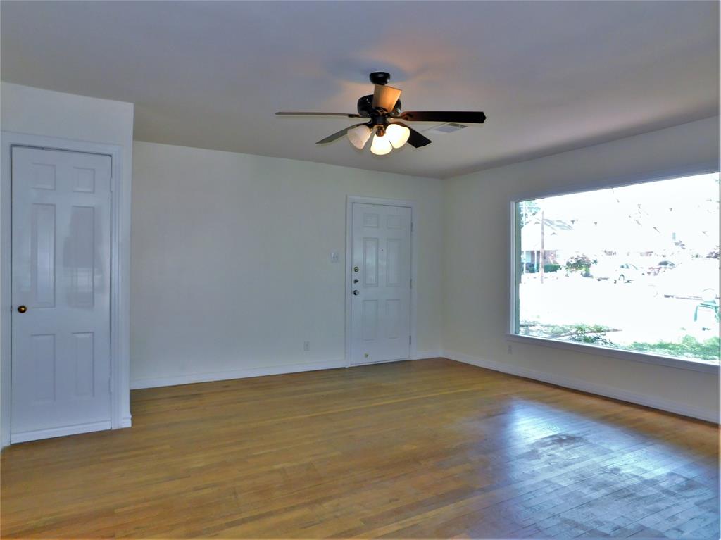 420 Fulton Street Denton, TX 76201 - Photo 5 of 23 a view of an empty room with wooden floor and a window