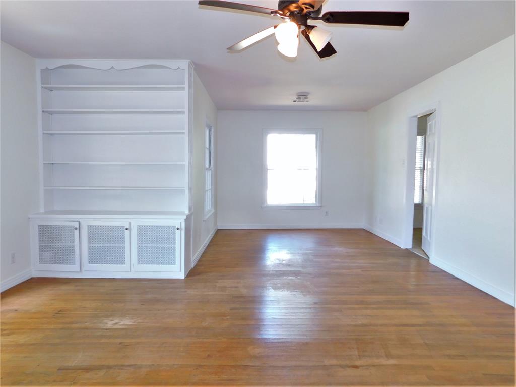 420 Fulton Street Denton, TX 76201 - Photo 6 of 23 a view of an empty room with a window and wooden floor