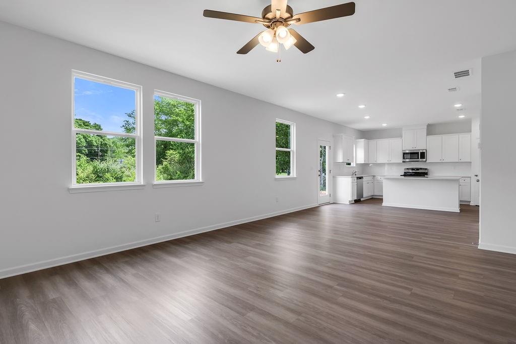 172 Sweet Water Lane Southeast Rome, GA 30161 - Photo 6 of 29 a view of an empty room with wooden floor and a window