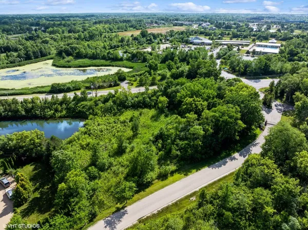 an aerial view of a houses with a lake view