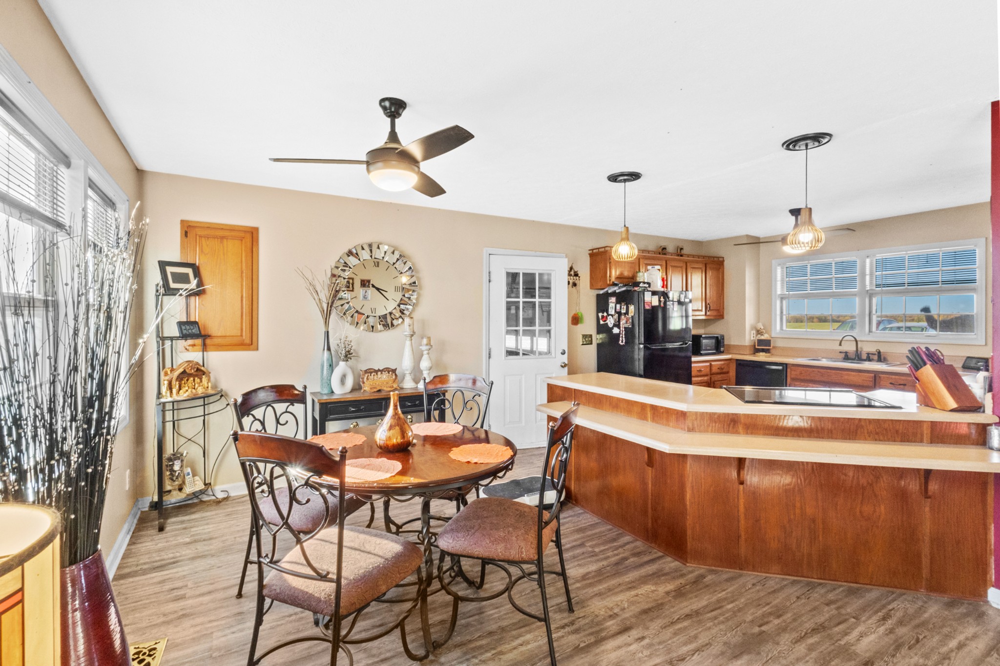 580 Gregory Road Westmoreland, TN 37186 - Photo 12 of 45 a dining room with wooden floor a chandelier a wooden table and chairs