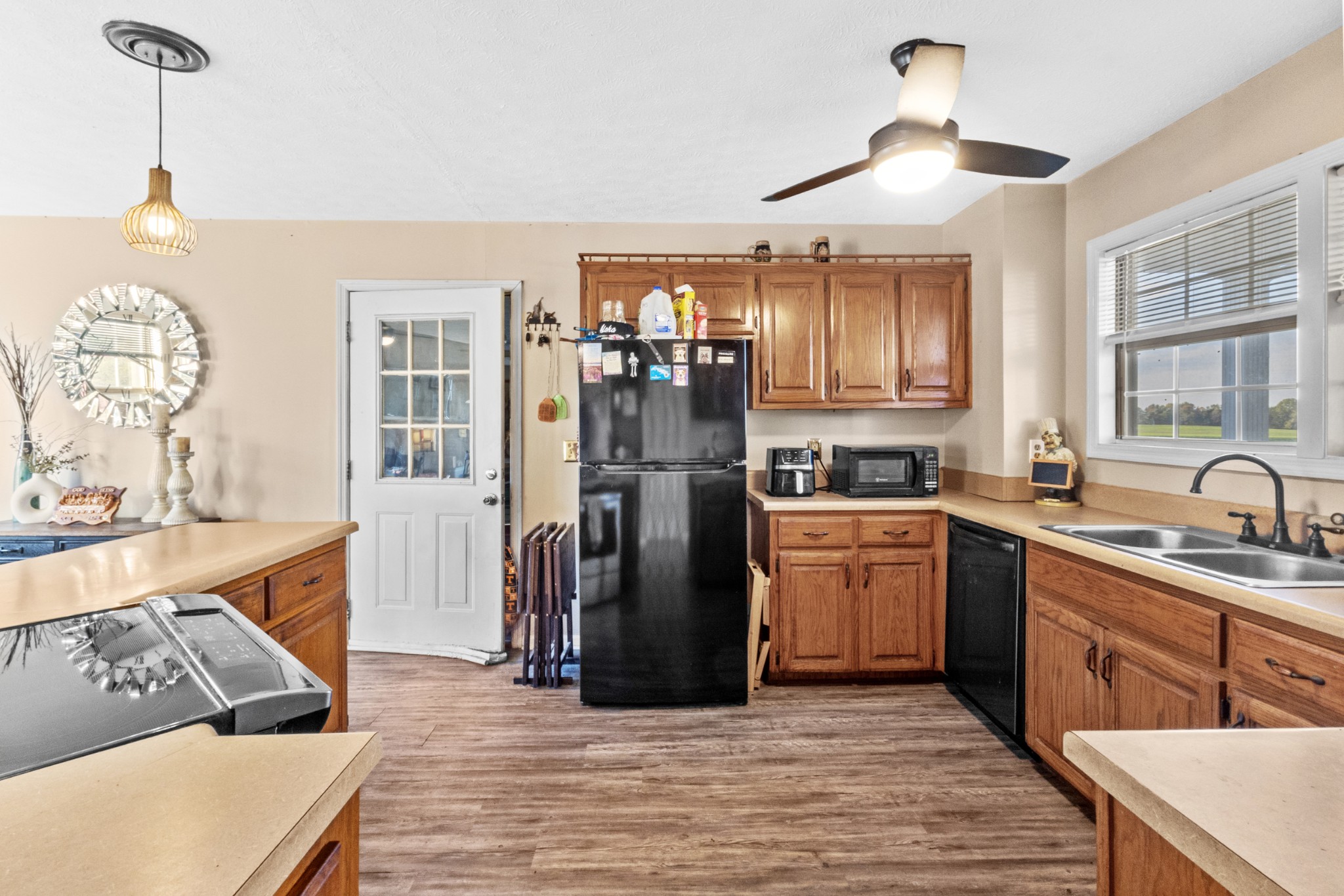 580 Gregory Road Westmoreland, TN 37186 - Photo 16 of 45 a kitchen with stainless steel appliances granite countertop a refrigerator a sink dishwasher a stove with wooden cabinets and floor