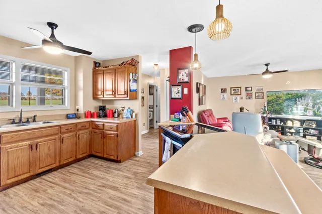 a very nice looking room with a large window cabinets and furniture