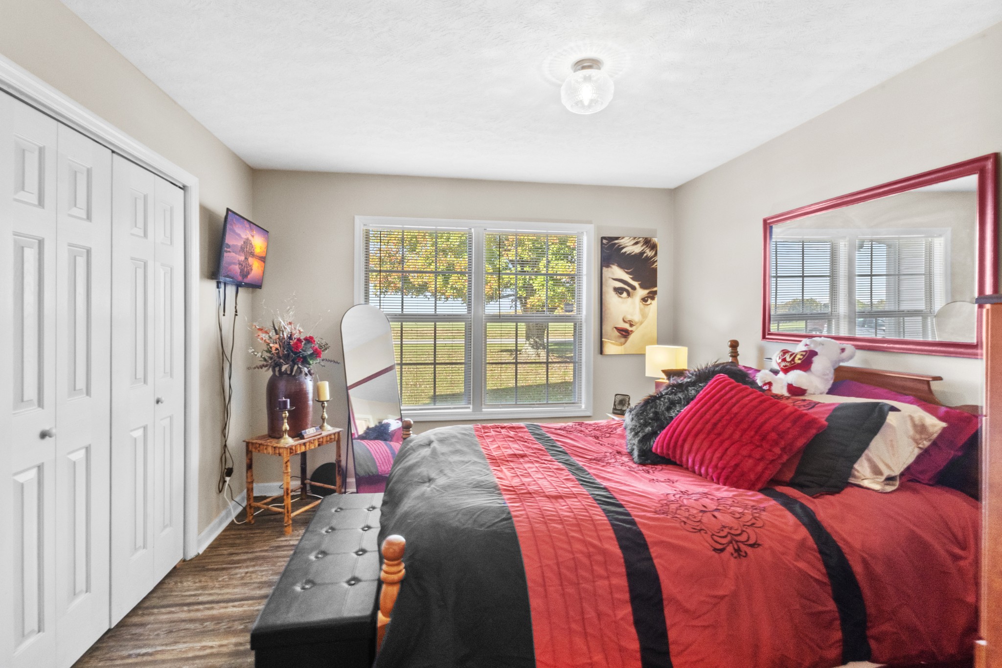 580 Gregory Road Westmoreland, TN 37186 - Photo 21 of 45 a bedroom with a bed a window and a chandelier