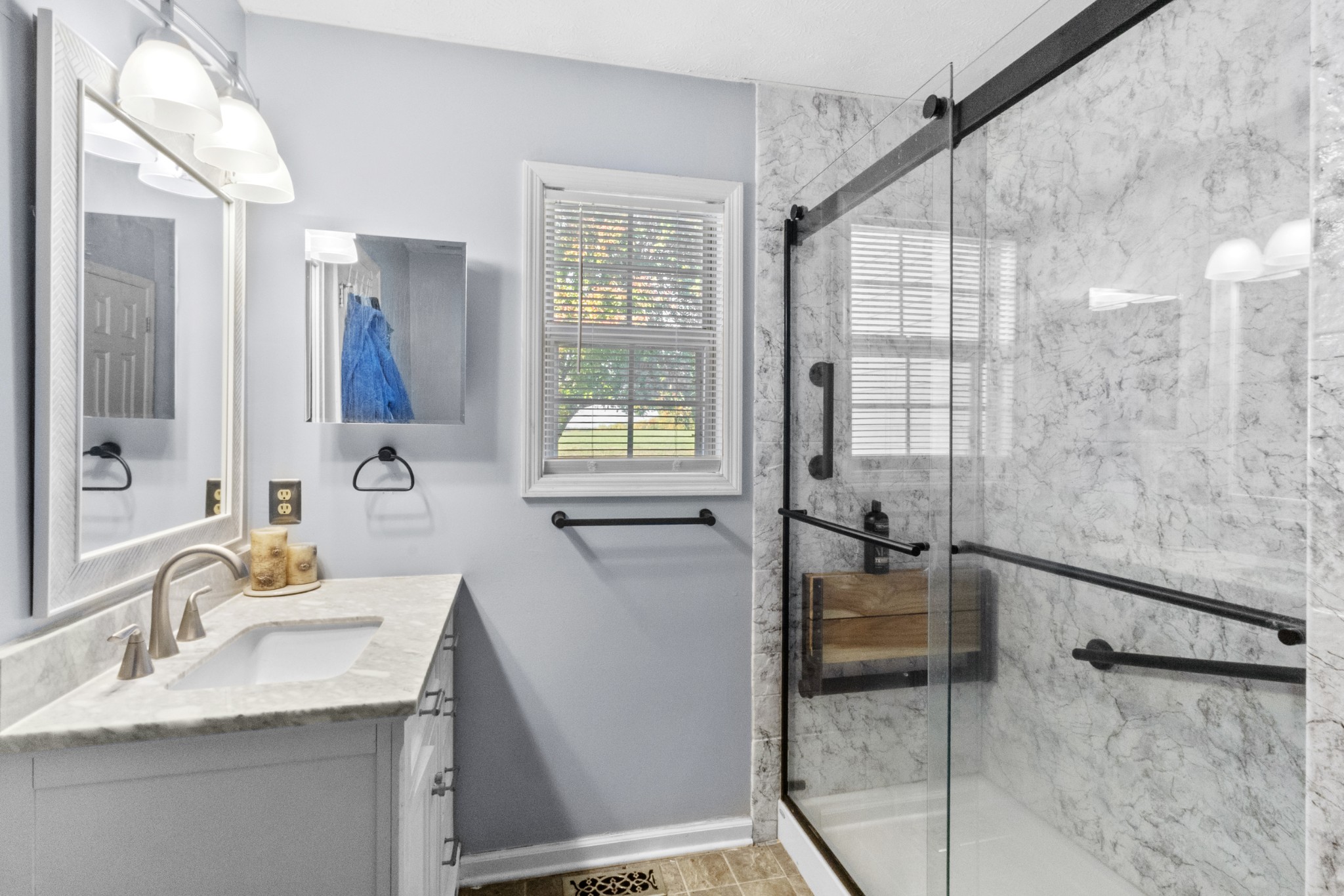 580 Gregory Road Westmoreland, TN 37186 - Photo 28 of 45 a bathroom with a granite countertop sink a mirror and a shower